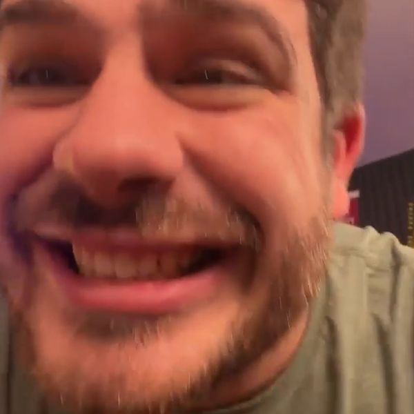 Avery grinning into his phone camera